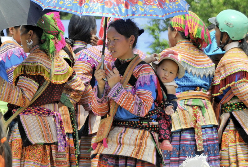 The women tend to wear their Sunday best to market. (Not least as it shows off their embroidery skills.)